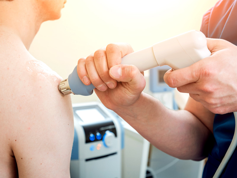 Patient getting shockwave therapy treatment to their shoulder